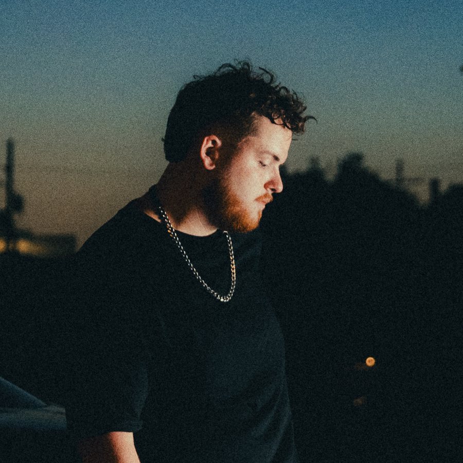 Tanner Castille at twilight, head bowed